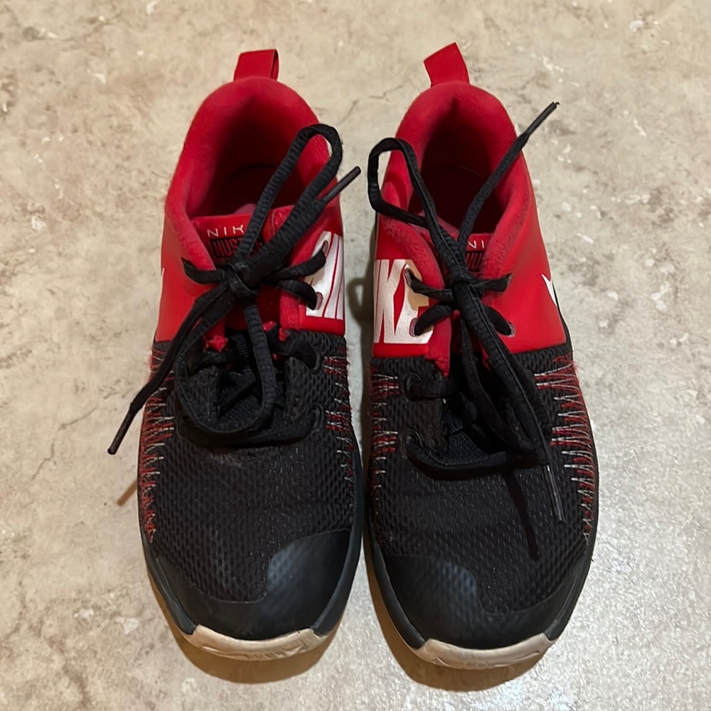 Used red Nike Hustle tennis shoes size 1Y kid